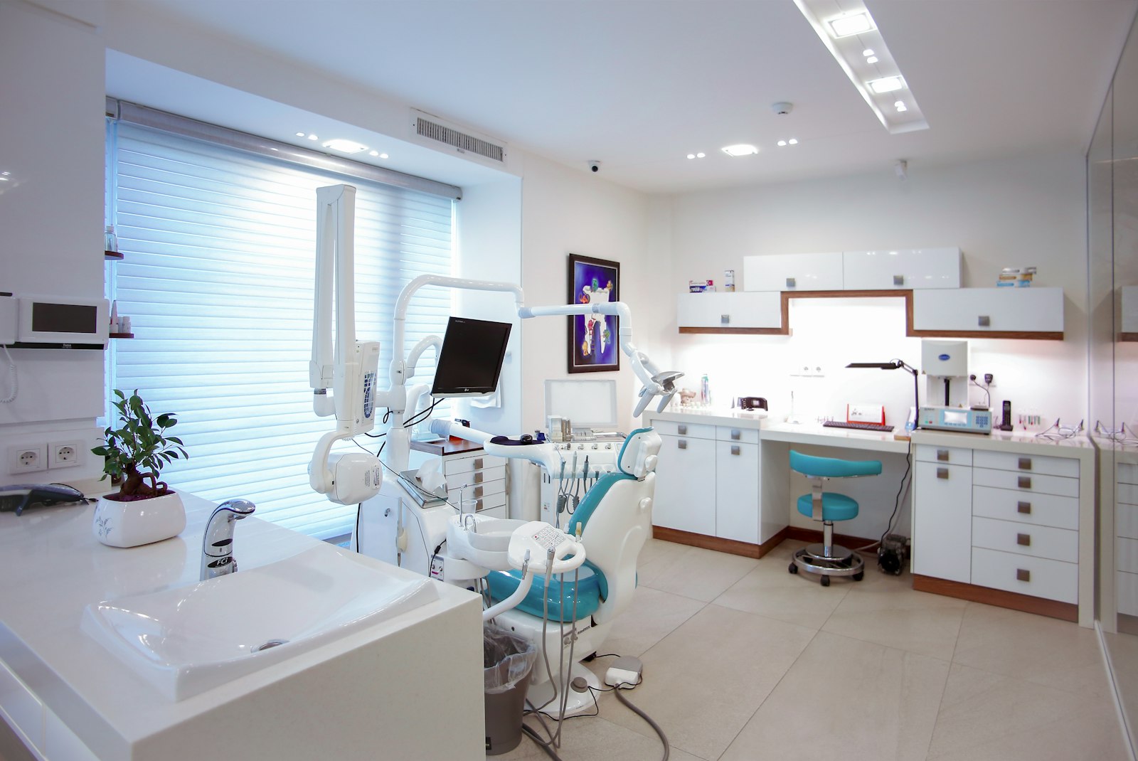 Bright modern dental clinic chair in clean white treatment room — dental aesthetics studio